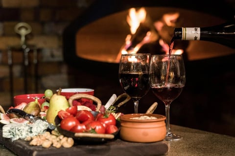 Wine by the suspended fireplace